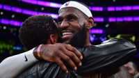 Los Angeles Lakers forward LeBron James (6) hugs agent Rich Paul after breaking the all-time scoring record in the third quarter against the Oklahoma City Thunder at Crypto.com Arena.