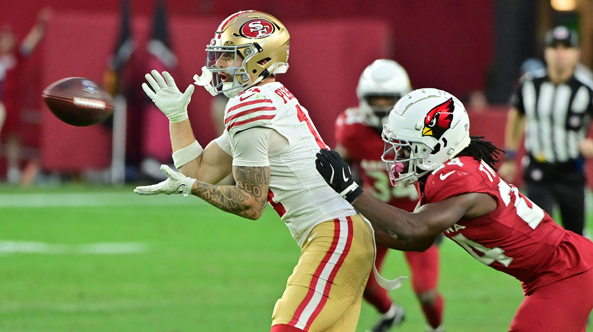 San Francisco 49ers wide receiver Ricky Pearsall (14) catches a pass as Arizona Cardinals cornerback Starling Thomas V (24) defends in the second half at State Farm Stadium.