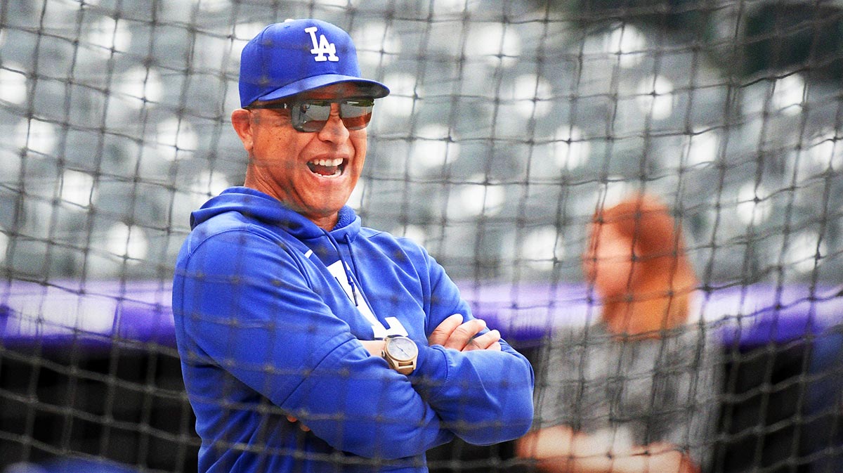 Los Angeles Dodgers manager Dave Roberts (30) watches warmups before the game against the Colorado Rockies at Coors Field.