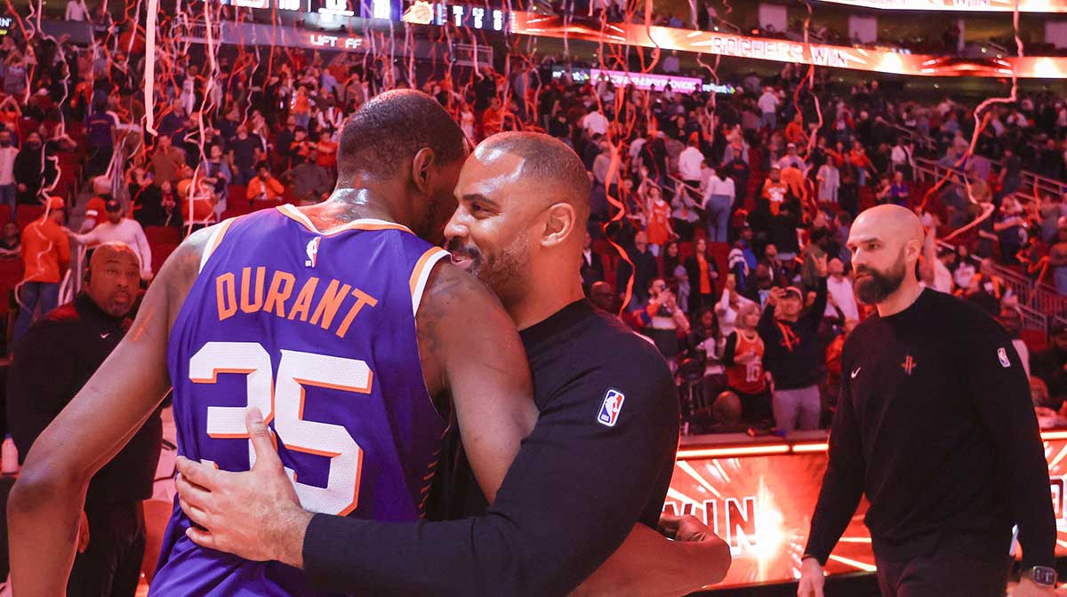 Rockets forward Kevin Durant (35) hugs Houston Rockets head coach Ime Udoka after a game at Toyota Center.