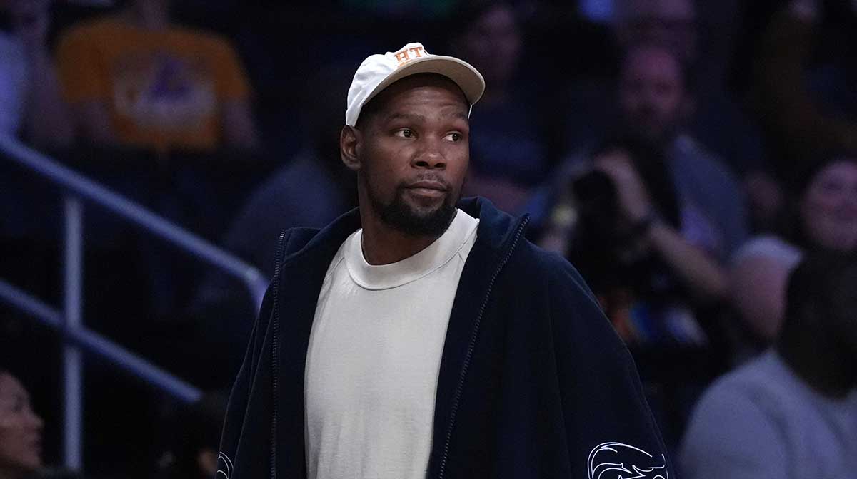 Rockets' Kevin Durant attends a WNBA game between the Atlanta Dream and LA Sparks at Crypto.com Arena with Mount Rushmore in the background
