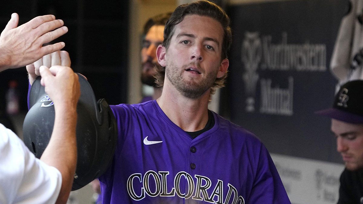 Colorado Rockies third base Ryan McMahon (24) celebrates after scoring a run against the Milwaukee Brewers.