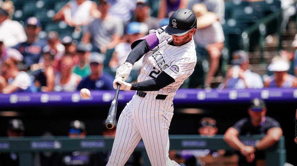 Colorado Rockies third baseman Ryan McMahon (24) hits a double in the second inning against the Minnesota Twins at Coors Field.