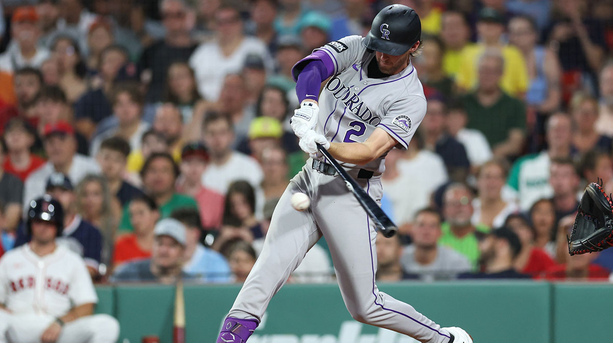 Colorado Rockies third baseman Ryan McMahon (24) hits an RBI single during the fifth inning against the Boston Red Sox at Fenway Park.