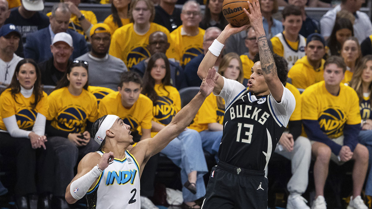 Milwaukee Bucks guard Ryan Rollins (13) shoots the ball while Indiana Pacers guard Andrew Nembhard (2) defends in the first half at Gainbridge Fieldhouse.