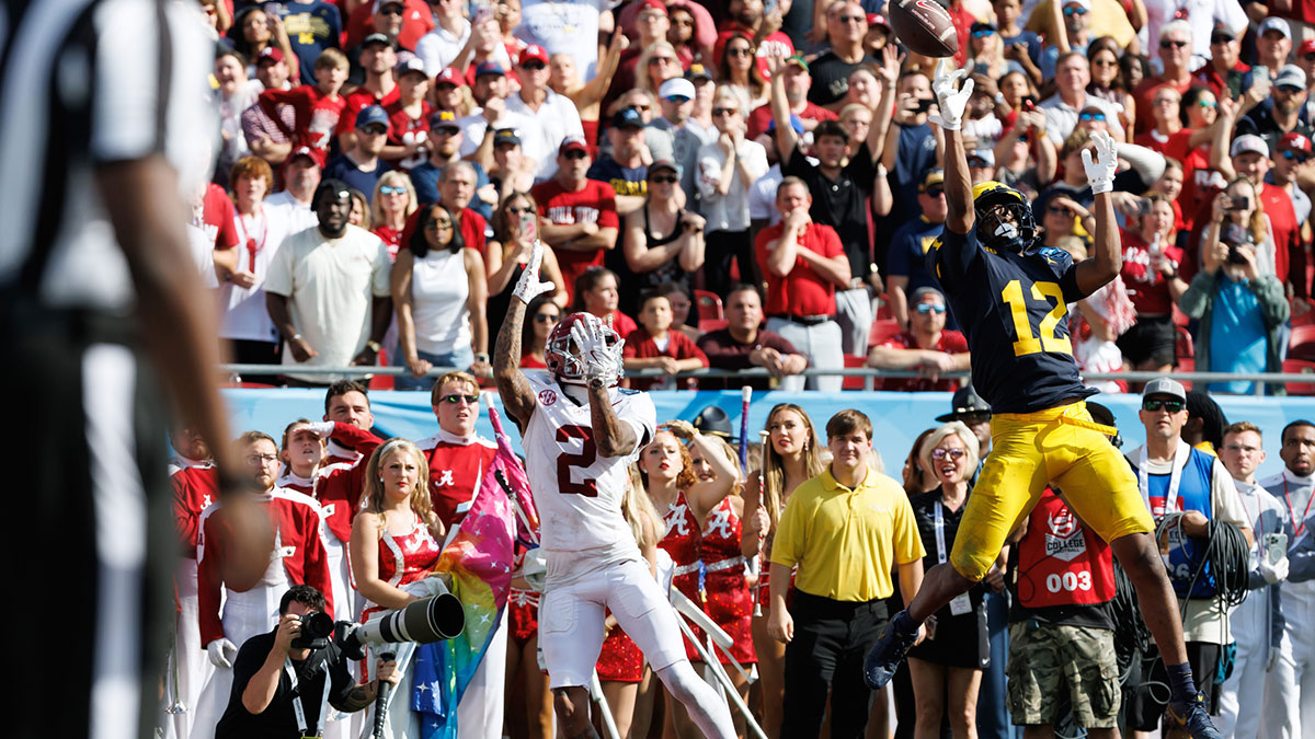Michigan Wolverines defensive back Aamir Hall (12) attempts to break up a pass to Alabama Crimson Tide wide receiver Ryan Williams (2) during the first half at Raymond James Stadium.