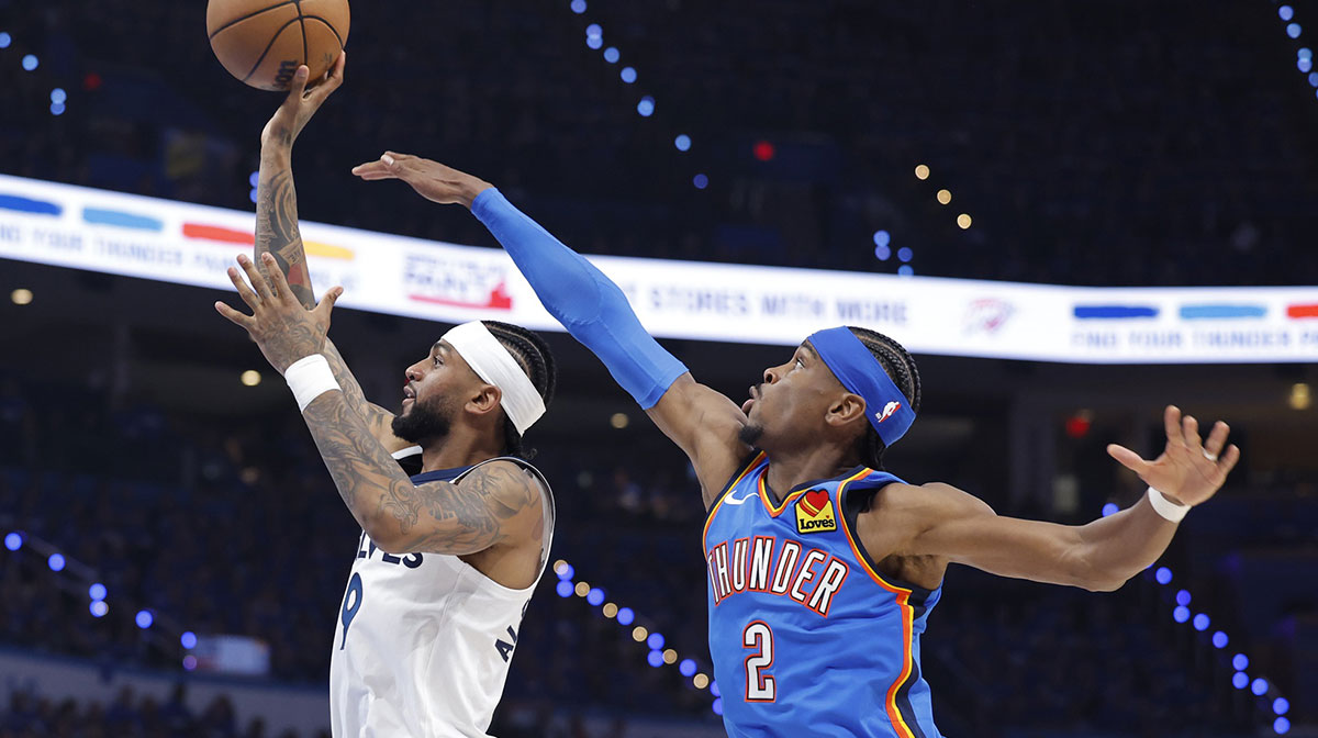 Minnesota Timberwolves guard Nickeil Alexander-Walker (9) shoots against Oklahoma City Thunder guard Shai Gilgeous-Alexander (2) in the third quarter during game two of the western conference finals for the 2025 NBA Playoffs at Paycom Center.