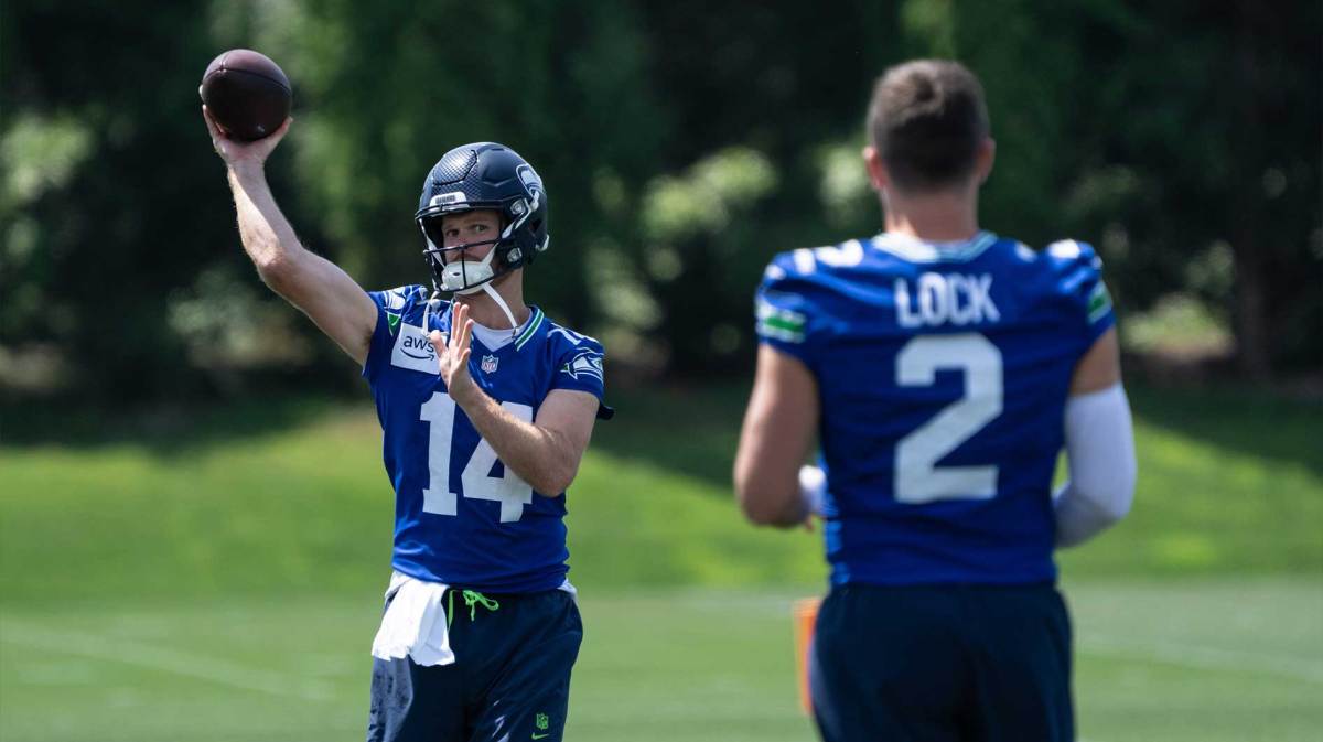 Seattle Seahawks quarterback Sam Darnold (14) passes the ball to quarterback Drew Lock (2) during mini-camp at Virginia Mason Athletic Center.