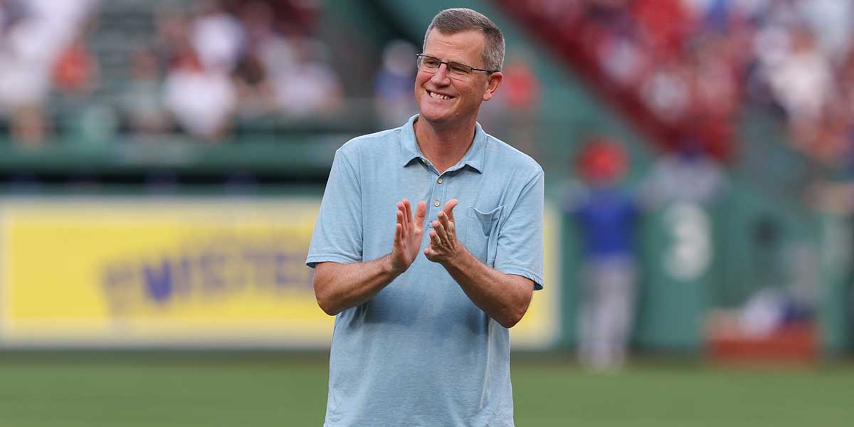 President and CEO of the Boston Red Sox Sam Kennedy applauds before a game against the Kansas City Royals at Fenway Park.