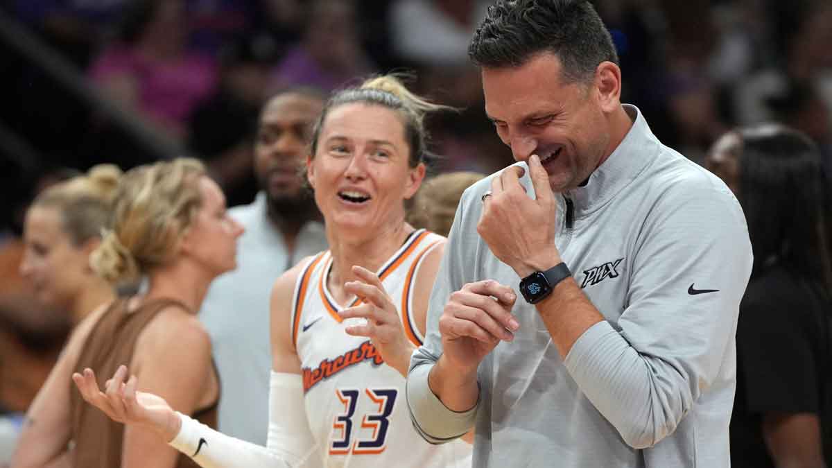 Phoenix Mercury head coach Nate Tibbitts laughs with guard Sami Whitcomb (33) in the second half against the Dallas Wings at Footprint Center.