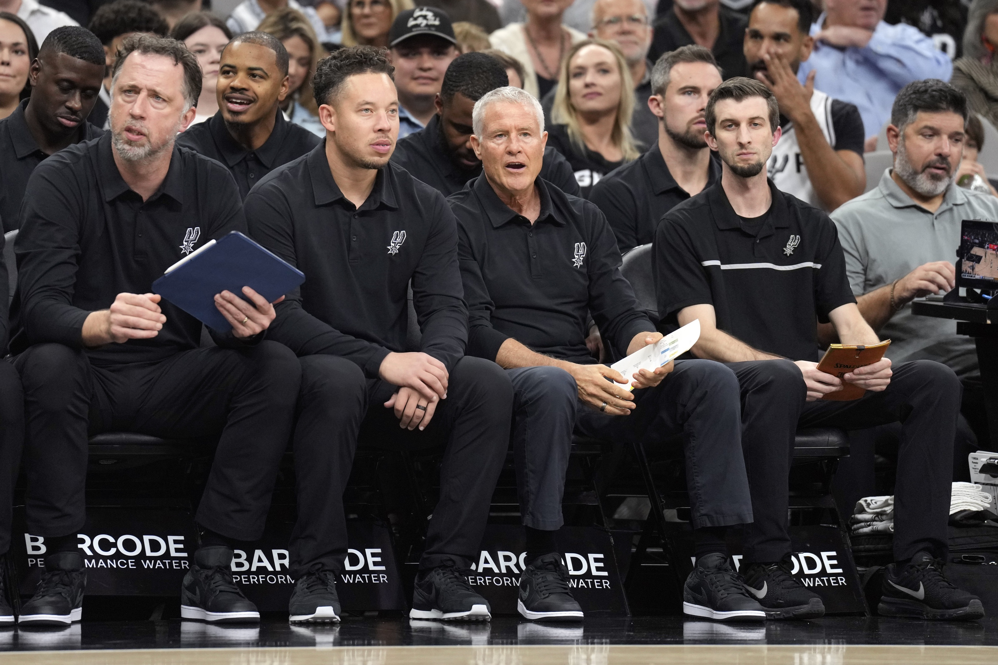 San Antonio Spurs assistant coaches Matt Nielsen, Mitch Johnson, Brett Brown and assistant coach Mike Noyes during the first half against the Minnesota Timberwolves at Frost Bank Center