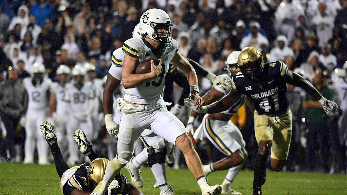 Baylor Bears quarterback Sawyer Robertson (13) runs for a short gain in overtime against the Colorado Buffaloes at Folsom Field.