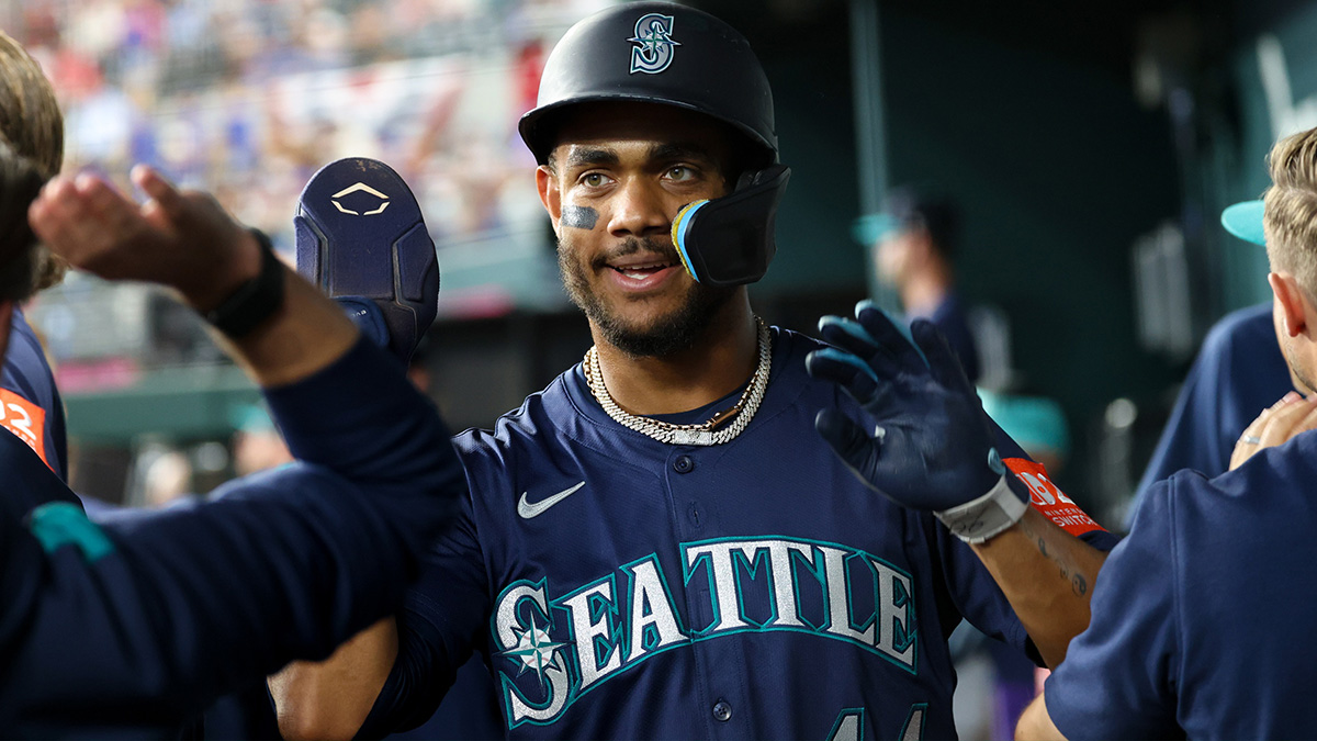 Seattle Mariners center fielder Julio Rodriguez (44) celebrates with teammates after scoring during the first inning against the Texas Rangers at Globe Life Field.