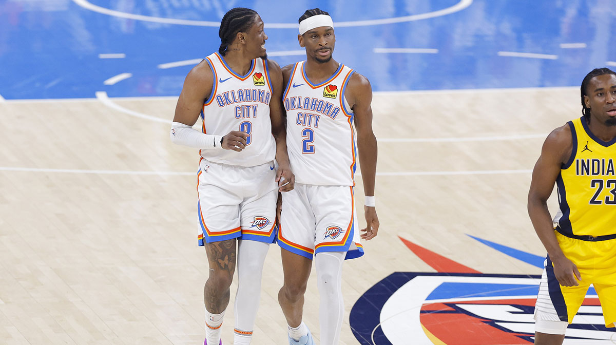 Oklahoma City Thunder forward Jalen Williams (8) and guard Shai Gilgeous-Alexander (2) walk back up the court in the first quarter against the Indiana Pacers during game five of the 2025 NBA Finals at Paycom Center.