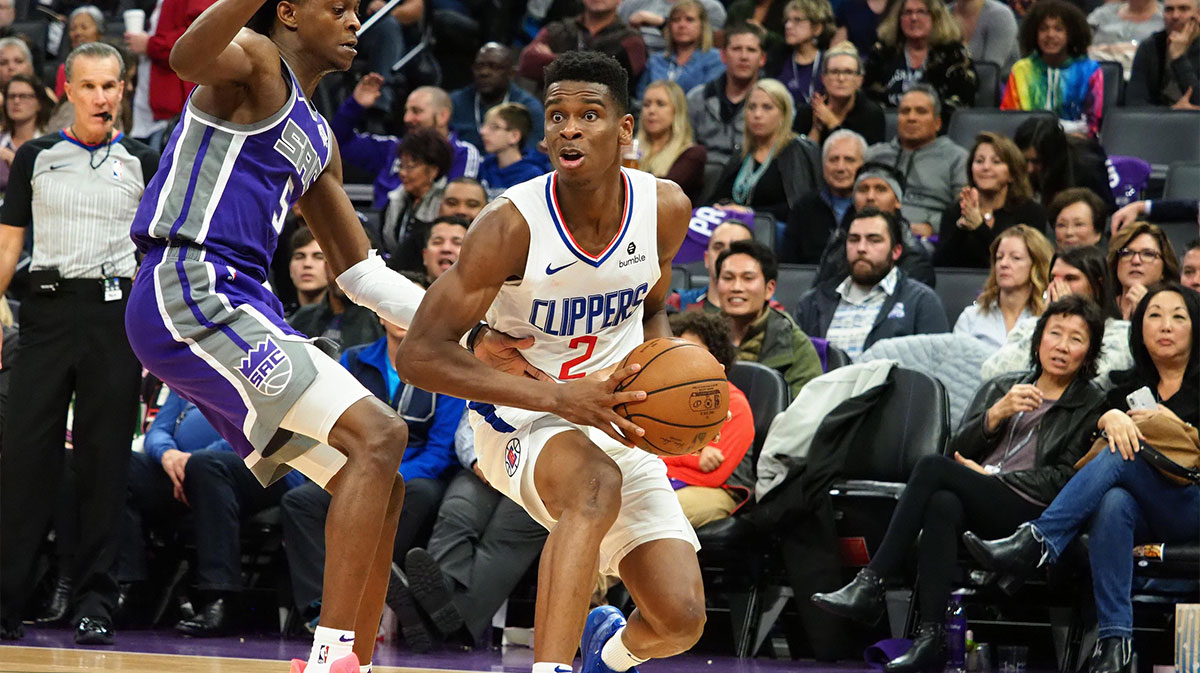 LA Clippers guard Shai Gilgeous-Alexander (2) controls the ball against Sacramento Kings guard De'Aaron Fox (5) during the second quarter at Golden 1 Center. 