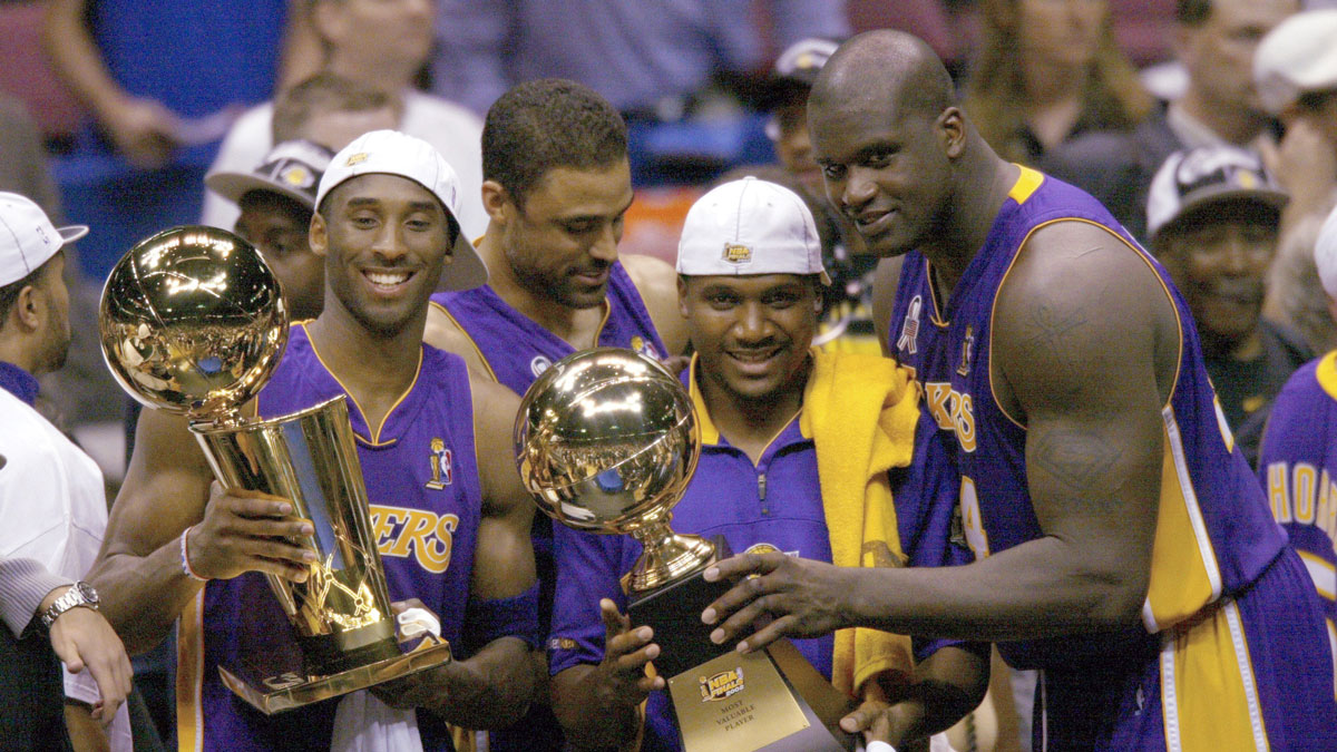 (left to right) Los Angeles Lakers Kobe Bryant, Lindsay Hunter and Shaquille O'Neal hold championship trophies after winning Game 4 of the NBA Finals at The Meadowlands.