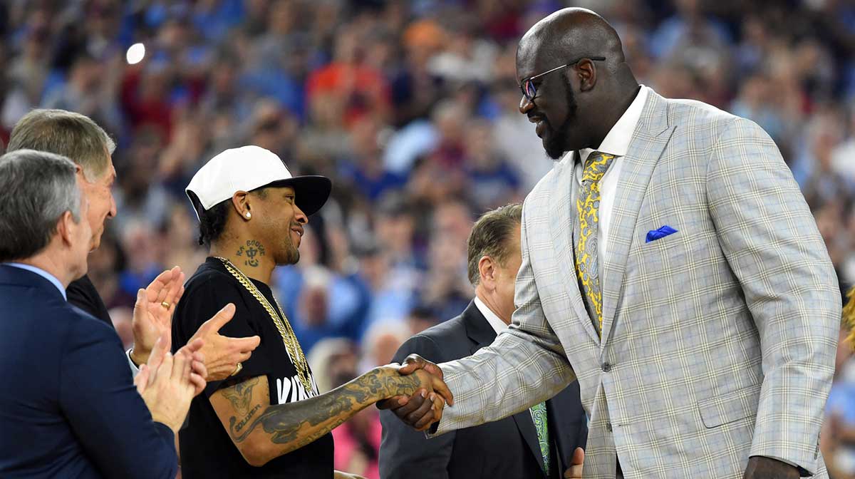 Shaquille O'Neal shakes hands with Allen Iverson as they are introduced at halftime of the championship game of the 2016 NCAA Men's Final Four after being inducted into the basketball hall of fame at NRG Stadium.