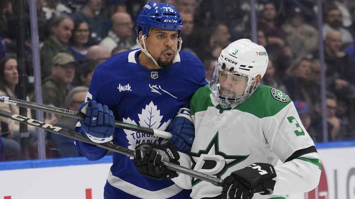 Dallas Stars defenceman Mathew Dumba (3) and Toronto Maple Leafs forward Ryan Reaves (75) collide during the first period at Scotiabank Arena.