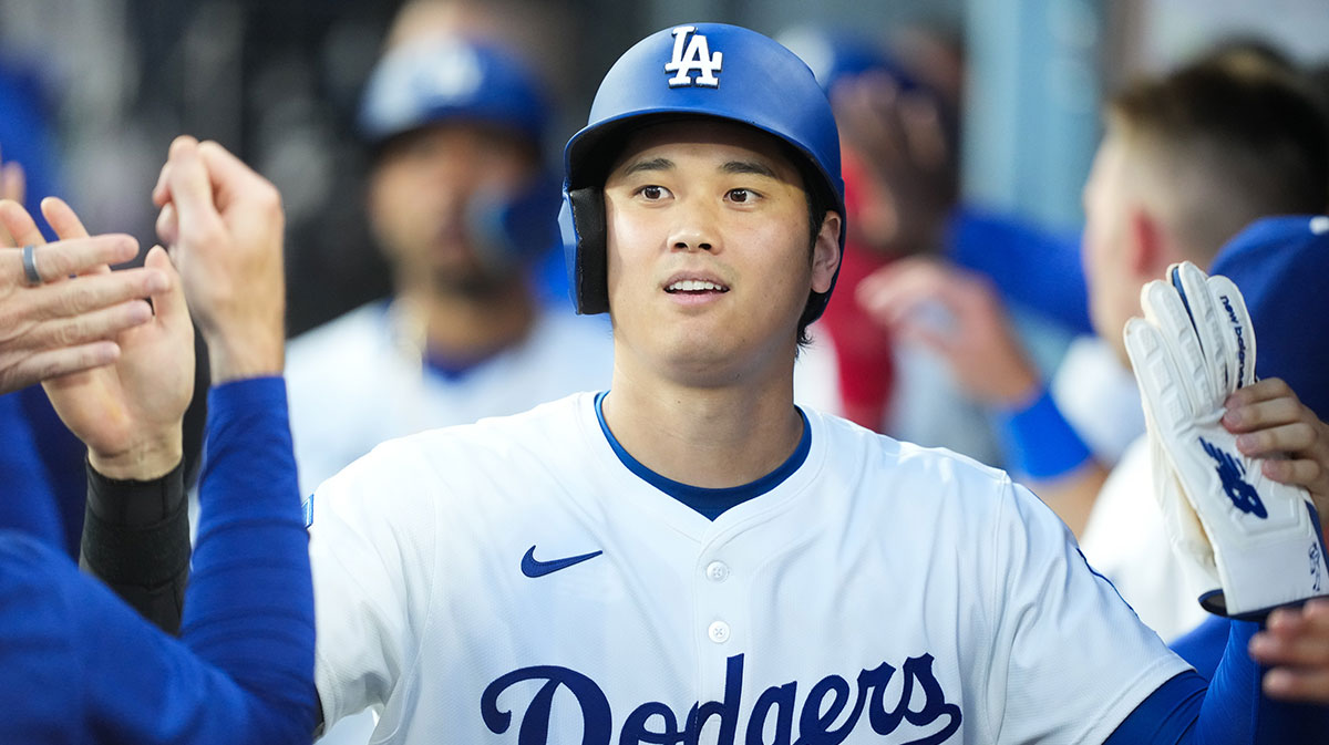 Los Angeles Dodgers designated hitter Shohei Ohtani (17) celebrates in the dugout after scoring a run during the third inning against the Chicago White Sox at Dodger Stadium.