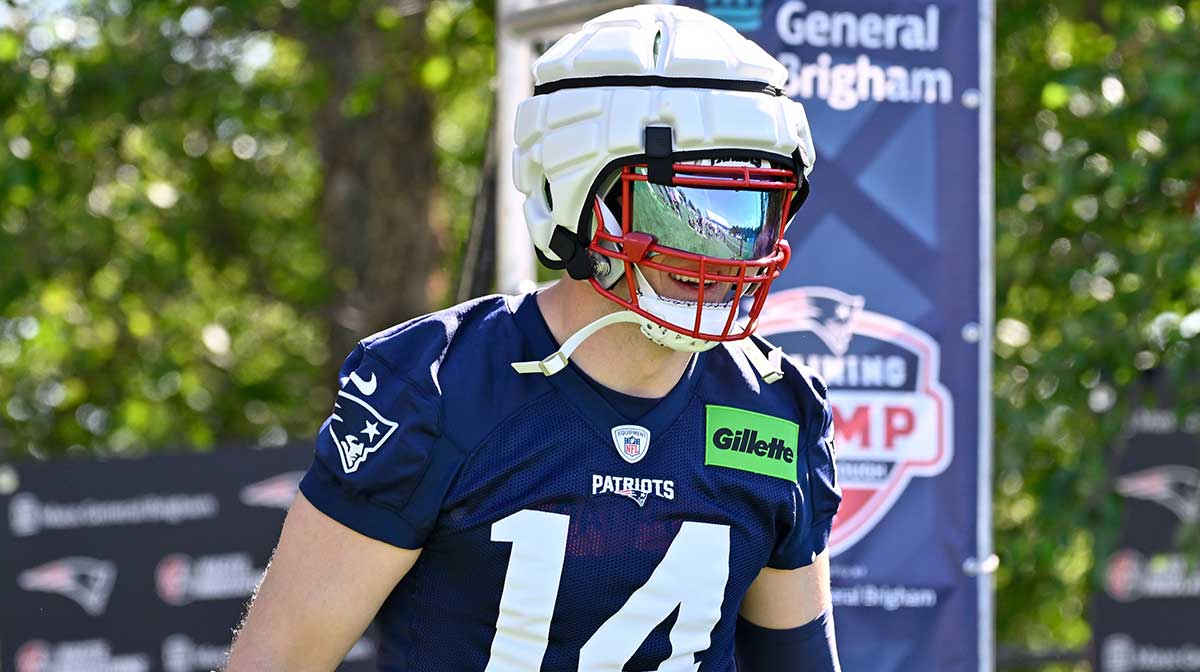 New England Patriots linebacker Robert Spillane (14) walks to the practice fields for training camp at Gillette Stadium.