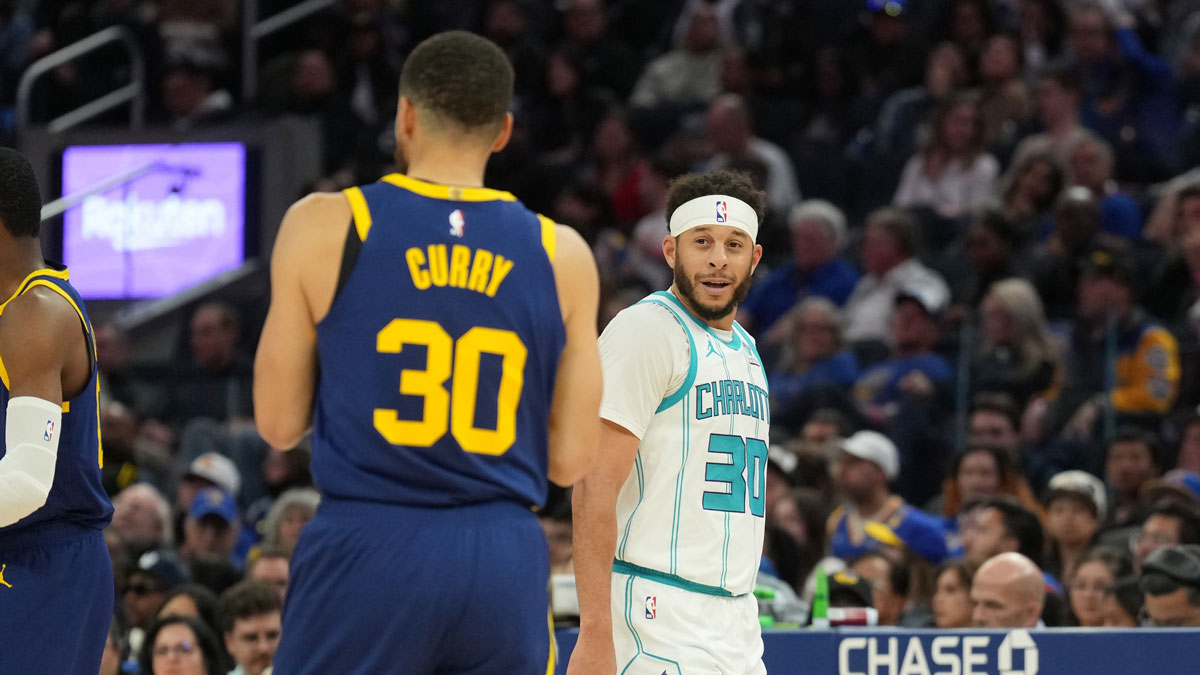 Charlotte Hornets guard Seth Curry (right) talks with Golden State Warriors guard Stephen Curry (left) during the fourth quarter at Chase Center.