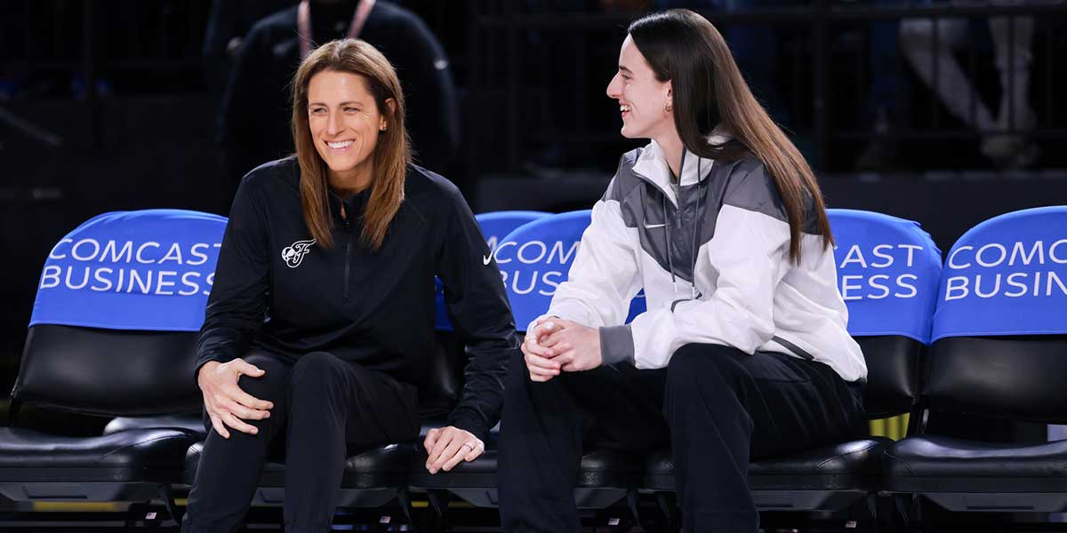 Indiana Fever guard Caitlin Clark talks with head coach Stephanie White before the game against the Washington Mystics at Entertainment & Sports Arena.