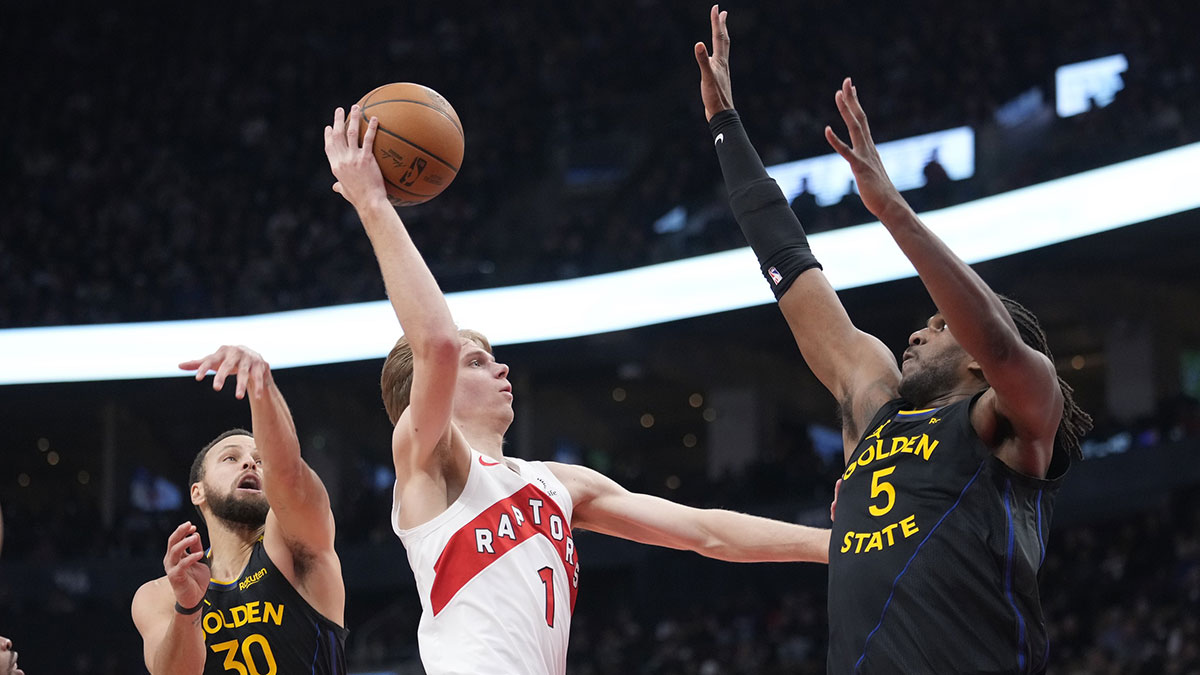 Toronto Raptors guard Gradey Dick (1) goes up to make a basket as Golden State Warriors forward Kevon Looney (5) and guard Stephen Curry (30) defend during the first half at Scotiabank Arena.