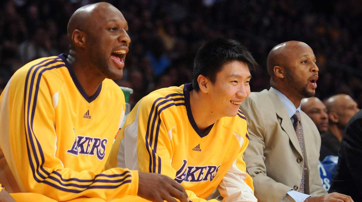 Los Angeles Laker forward Lamar Odom (7), guard Sun Yue (9) and assistant coach Brian Shaw watch from the bench during the Lakers' 109-103 loss to the Orlando Magic at the Staples Center.