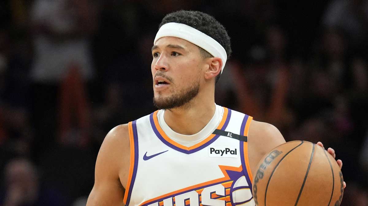 Phoenix Suns guard Devin Booker (1) dribbles against the San Antonio Spurs during the second half at Footprint Center. Devin Booker was initially reported to be starting PG for the Suns, but a report suggested Jalen Green will fill the role.