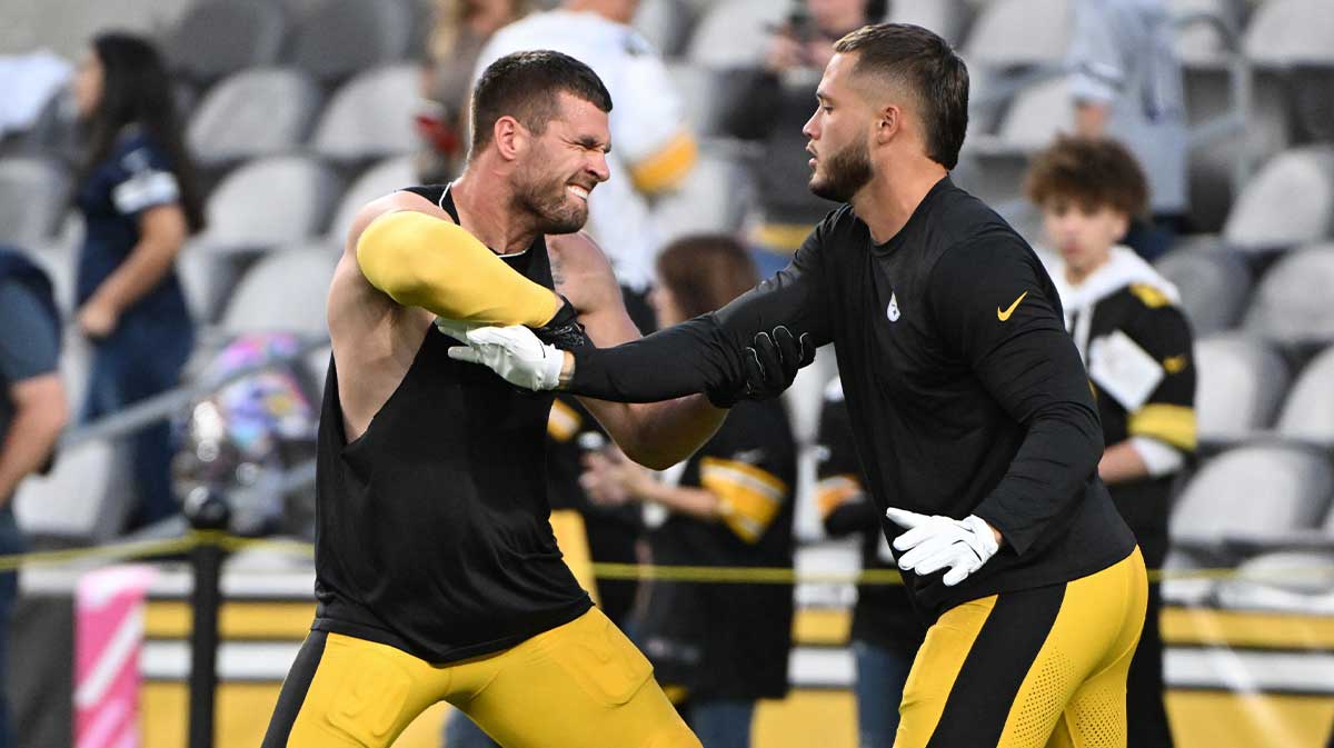 Pittsburgh Steelers linebackers T.J. Watt (90) and Nick Herbig (51) work out before a game against the Dallas Cowboys at Acrisure Stadium.