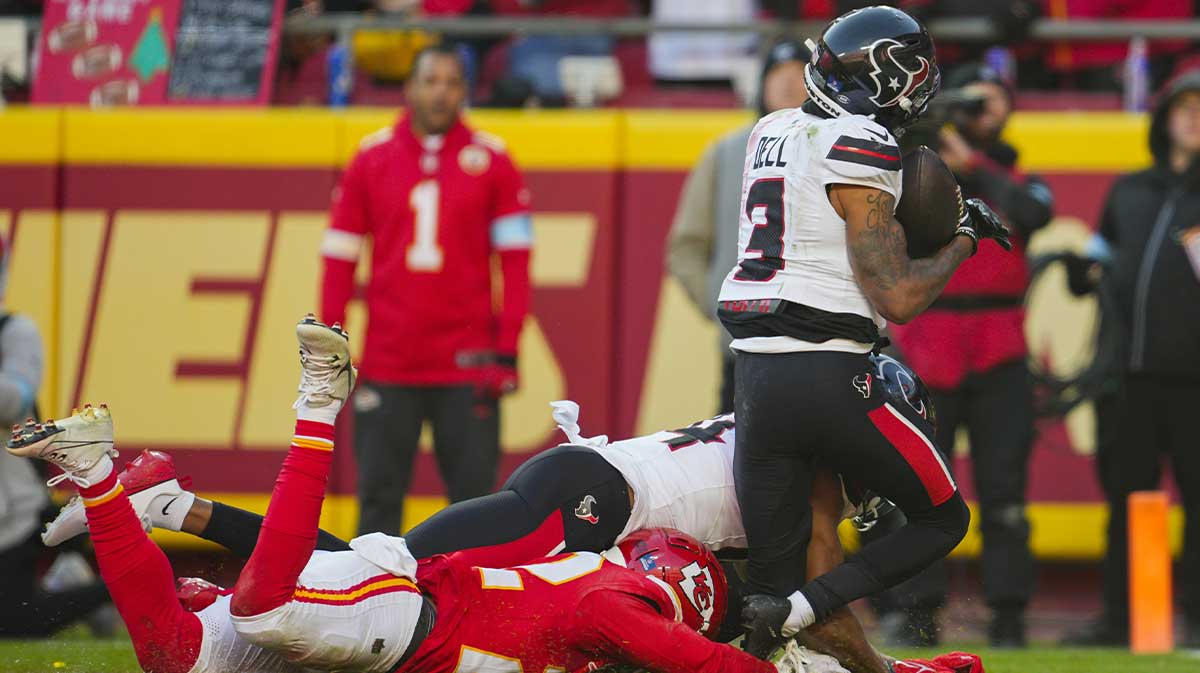 Houston Texans wide receiver Tank Dell (3) catches a touchdown pass against Kansas City Chiefs cornerback Trent McDuffie (22) during the second half at GEHA Field at Arrowhead Stadium.