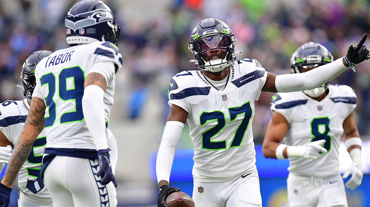 Seattle Seahawks cornerback Tariq Woolen (27) celebrates after intercepting a pass intended for Los Angeles Rams running back Kyren Williams (23) during the first half at SoFi Stadium.