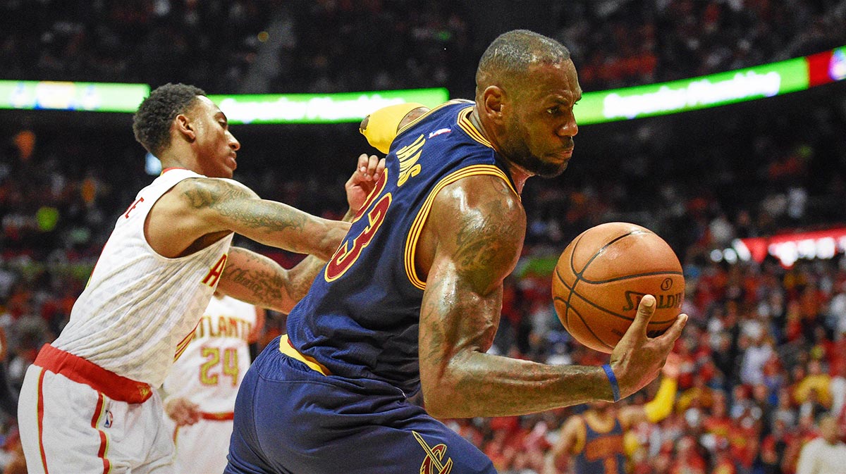 Cleveland Cavaliers forward LeBron James (23) is fouled by Atlanta Hawks guard Jeff Teague (0) during the second half in game three of the second round of the NBA Playoffs at Philips Arena. The Cavaliers defeated the Hawks 121-108.