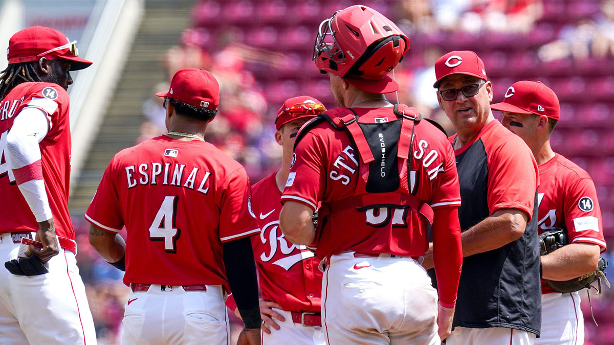 Cincinnati Reds manager Terry Francona (77) shakes hands with outfielder TJ Friedl (29) after the victory over the Colorado Rockies at Great American Ball Park.