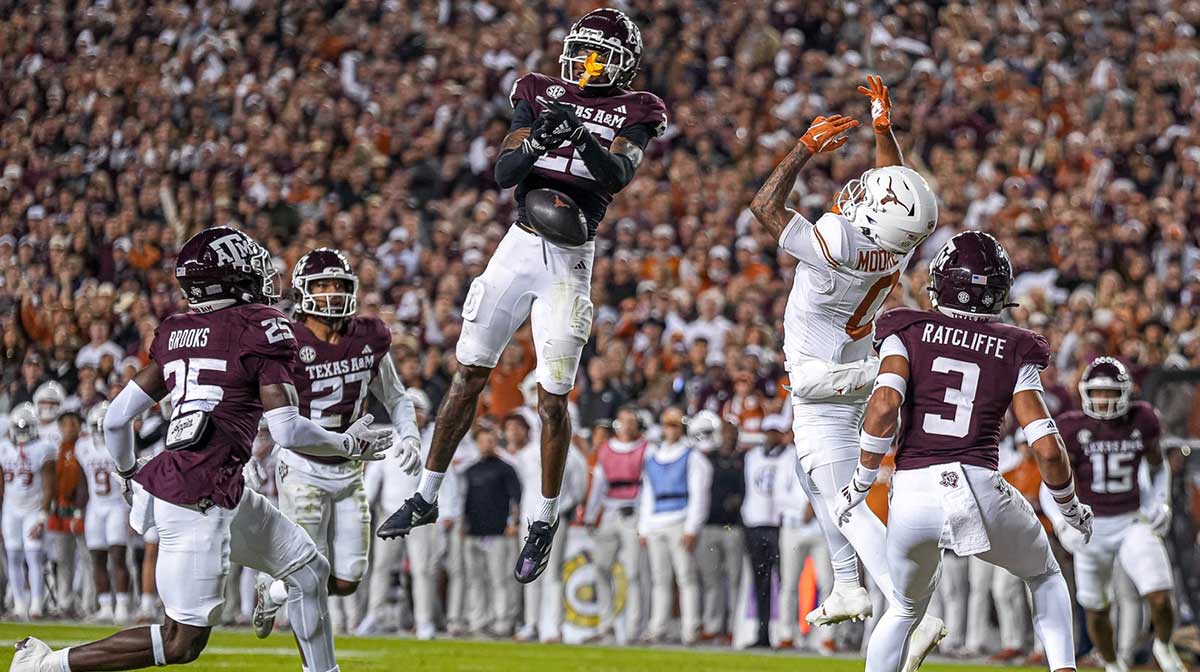 Texas A&M defensive back Will Lee III (26) misses an interception intended for Texas Longhorns receiver DeAndre Moore Jr. (0) during the Lone Star Showdown at Kyle Field on Saturday, Nov. 30, 2024 in College Station, Texas.