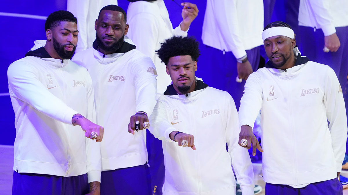 Los Angeles Lakers players Anthony Davis and LeBron James and Quinn Cook and Kentavious Caldwell-Pope pose with their 2020 NBA Championship rings before a game against the Los Angeles Clippers at Staples Center.