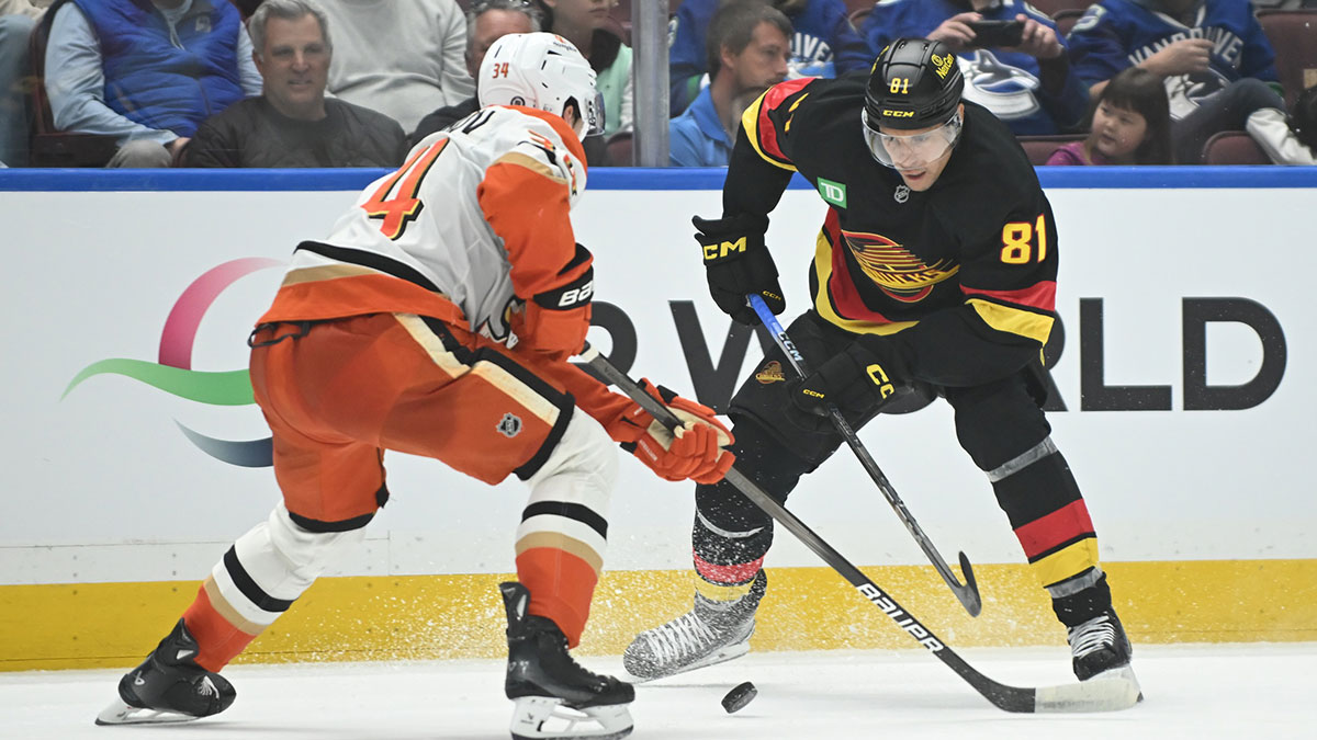 Vancouver Canucks forward Dakota Joshua (81) controls the puck against Anaheim Ducks defenseman Pavel Mintyukov (34) at Rogers Arena.