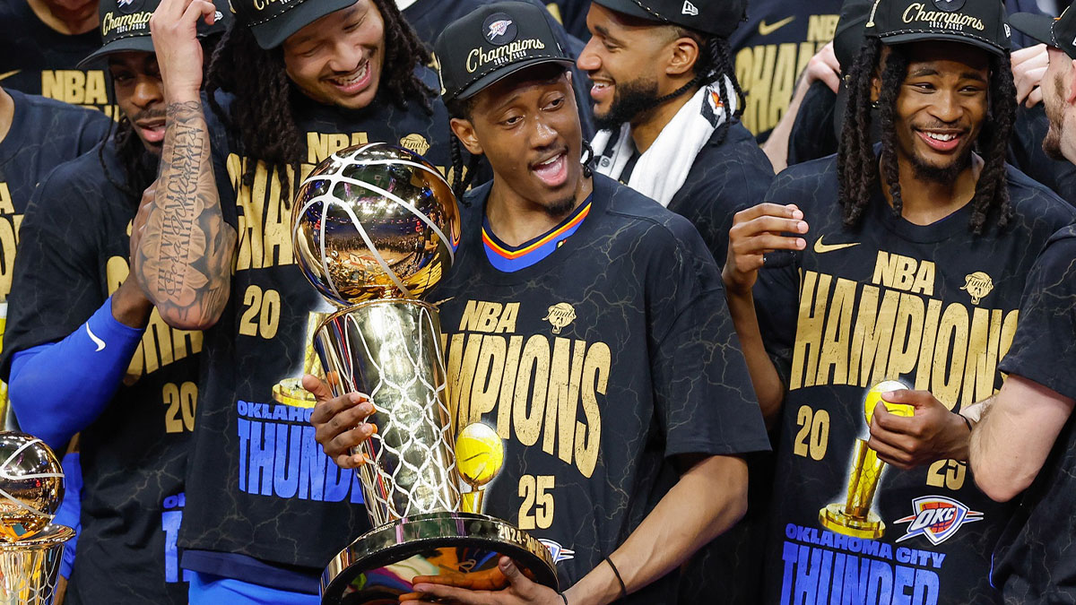 Thunder forward Jalen Williams (8) holds the NBA Larry O'Brien Championship Trophy at the end of game seven of the 2025 NBA Finals after defeating the Indiana Pacers at Paycom Center