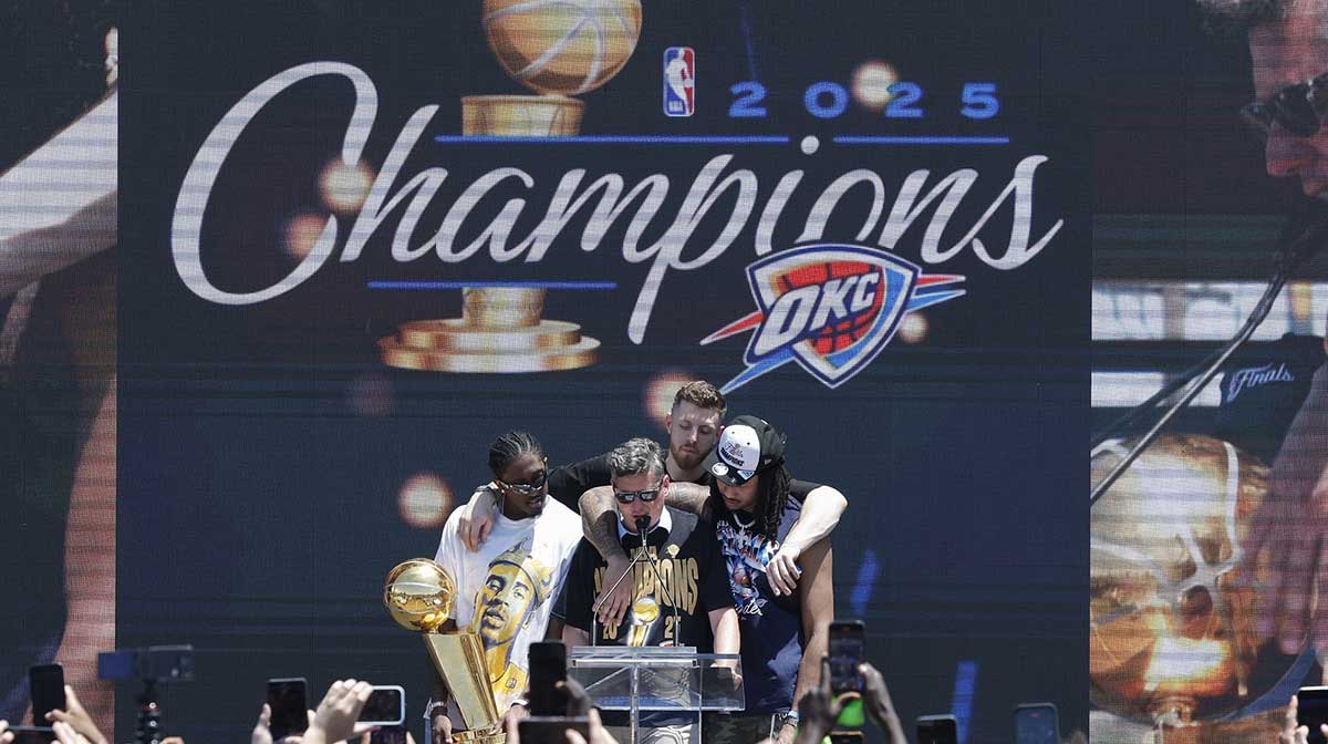 Thunder forward Jalen Williams, left, Oklahoma City Thunder center Isaiah Hartenstein, back, and Oklahoma City Thunder forward Jaylin Williams, right, gather around Oklahoma City Mayor David Holt during the Oklahoma City Thunder Champions parade closing ceremony at Scissortail Park