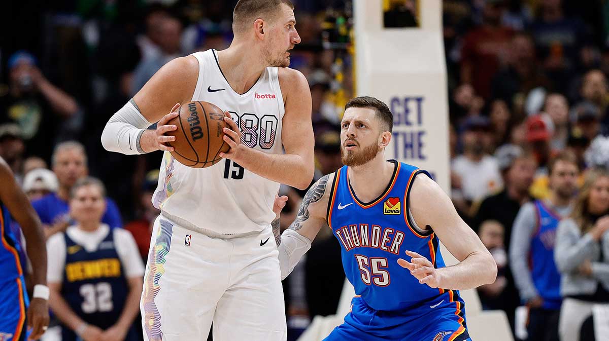 Nuggets center Nikola Jokic (15) controls the ball as Oklahoma City Thunder center Isaiah Hartenstein (55) guards in the first quarter during game six of the second round for the 2025 NBA Playoffs at Ball Arena with the Pacers and Nuggets logos in the background