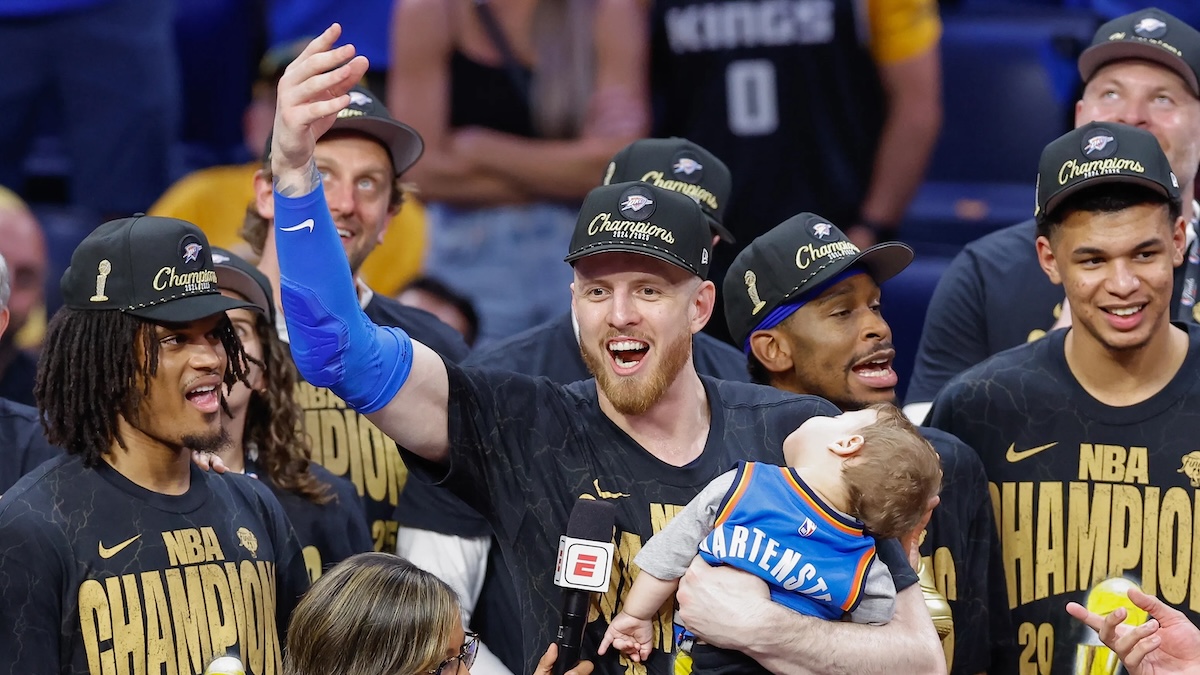 Oklahoma City Thunder center Isaiah Hartenstein (55) holds his son during the NBA Championship trophy presentation after game seven of the 2025 NBA Finals against the Indiana Pacers at Paycom Center.