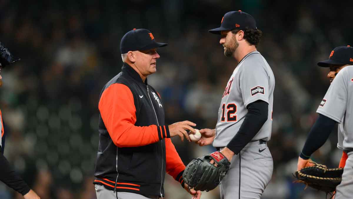 Tigers manager A.J. Hinch (14) pulls starting pitcher Casey Mize (12