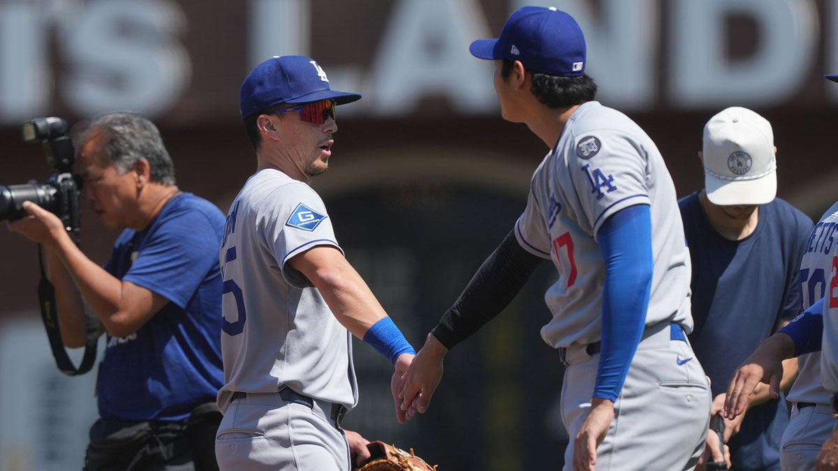 Los Angeles Dodgers third baseman Tommy Edman (center left) and starting pitcher Shohei Ohtani (center right) celebrate after defeating the San Francisco Giants at Oracle Park.