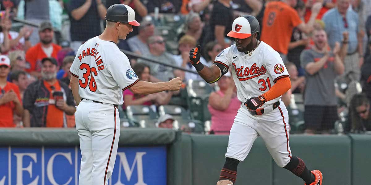 Baltimore Orioles outfielder Cedric Mullins (31) greeted by coach Tony Mansolino (36) following his two-run home run in the fourth inning against the Texas Rangers at Oriole Park at Camden Yards.