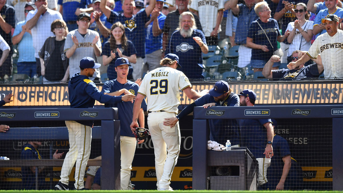 Milwaukee Brewers pitcher Trevor Megill (29) celebrates with teammates in the dugout after ending the top of the tenth inning against the Los Angeles Dodgers at American Family Field.
