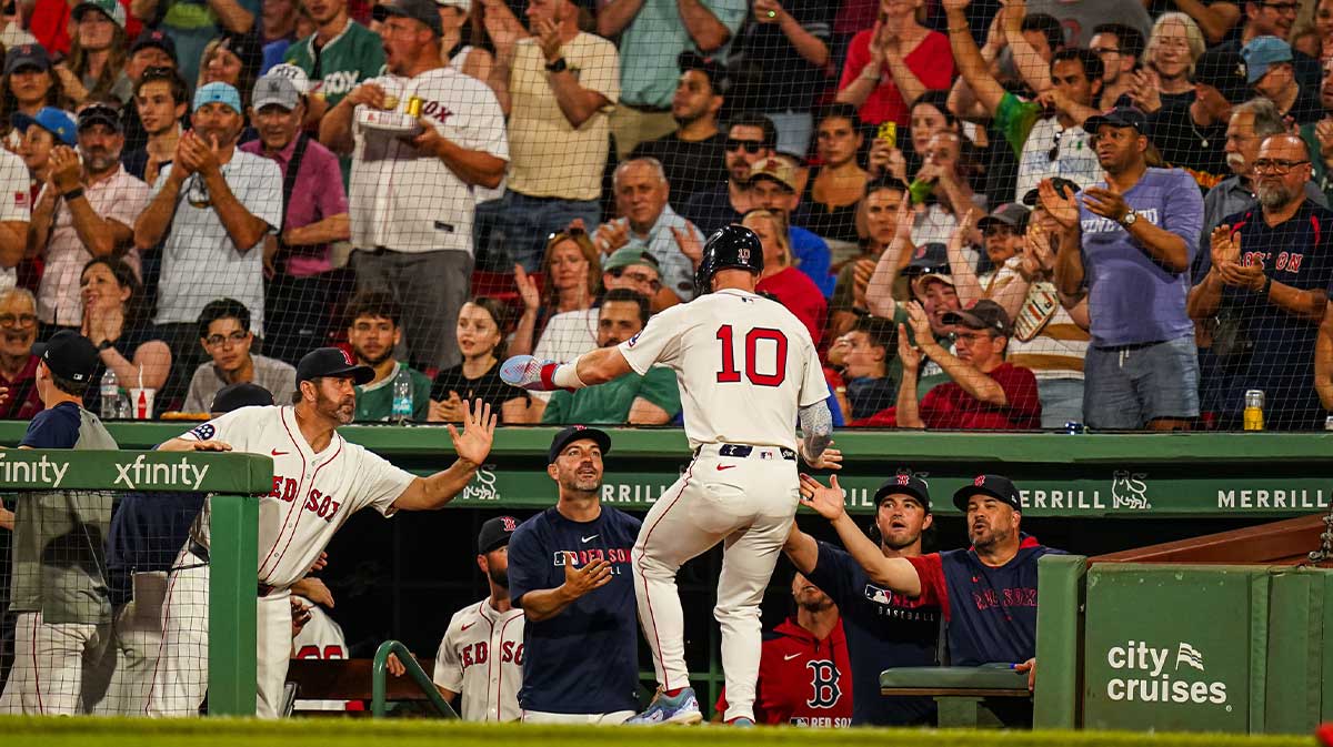 Boston Red Sox shortstop Trevor Story (10) is congratulated after scoring against the Colorado Rockies in the sixth inning at Fenway Park.