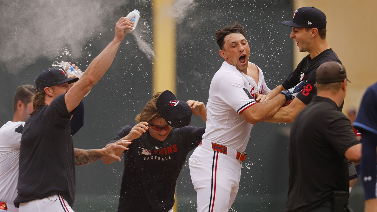 Teammates surround Minnesota Twins designated hitter Brooks Lee (2) after he laid down a walk-off bunt single against the Tampa Bay Rays in the ninth inning at Target Field.