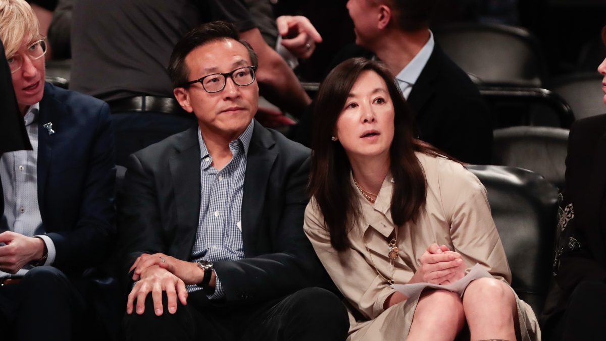 Taiwanese businessman Joe Tsai (left) looks on during the second half of the preseason WNBA game between the New York Liberty and the China National Team at Barclays Center.