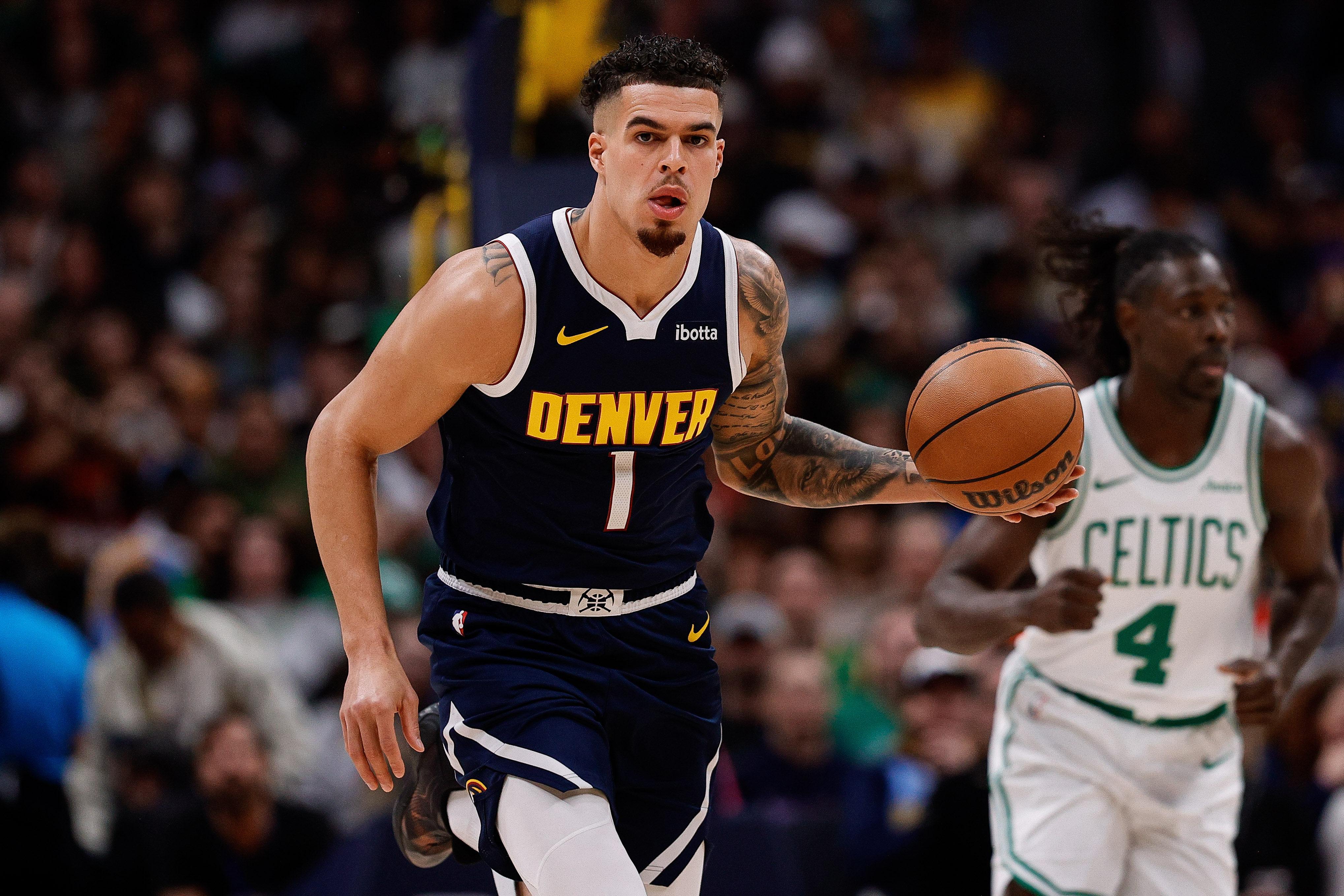 Denver Nuggets forward Michael Porter Jr. (1) dribbles the ball up court in the first quarter against the Boston Celtics at Ball Arena.