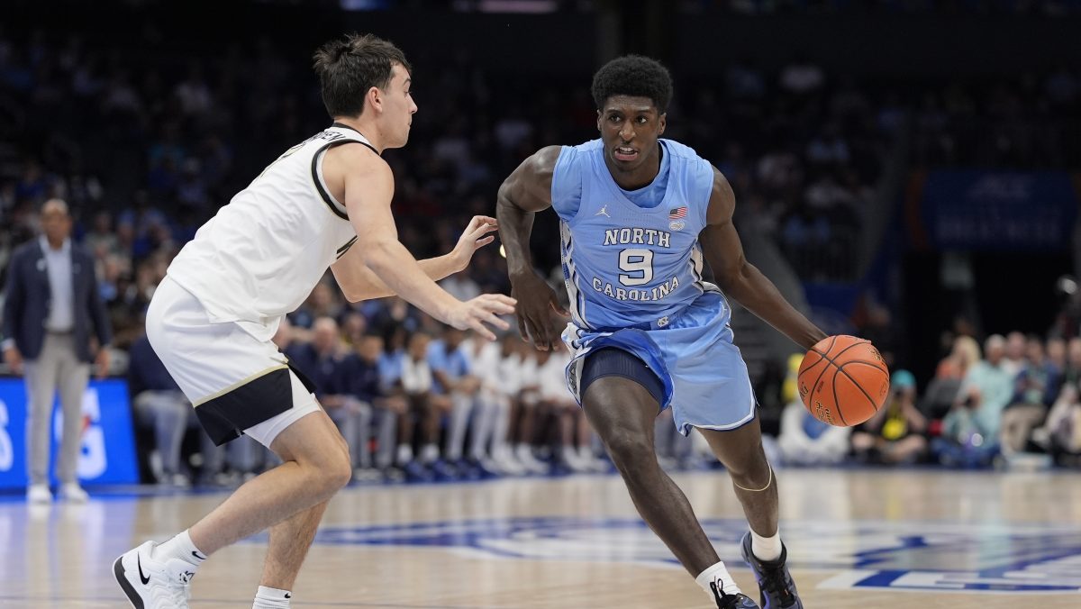 North Carolina Tar Heels guard Drake Powell (9) goes to the basket against Wake Forest Demon Deacons guard Parker Friedrichsen (7) during the first half at Spectrum Center.